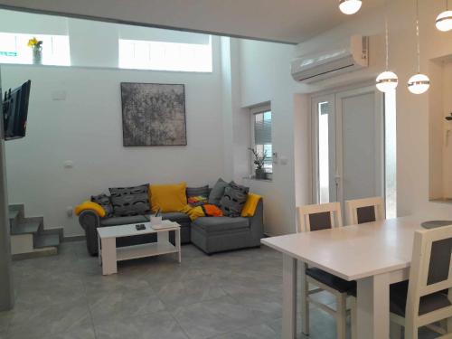 a living room with a couch and a table at Apartments Mare in Pula