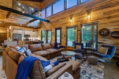 a large living room with a large couch and chairs at Unwind in Style! *NEW* Sip and Stay Hideaway in Broken Bow