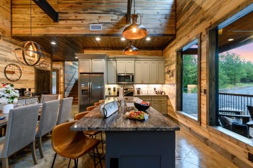 a kitchen and dining room of a log cabin at Unwind in Style! *NEW* Sip and Stay Hideaway in Broken Bow