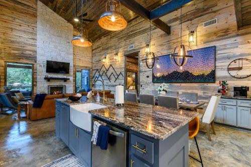 a kitchen with blue cabinets and a living room at Unwind in Style! *NEW* Sip and Stay Hideaway in Broken Bow