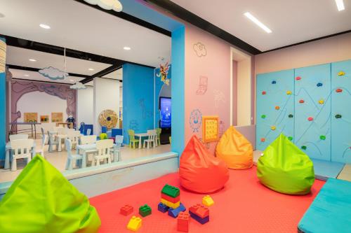 a childrens play room with colorful toys on the floor at Medora Auri Family Beach Resort in Podgora