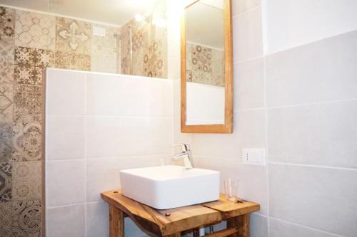 a bathroom with a white sink and a mirror at Casa Cucuc in Frisanco
