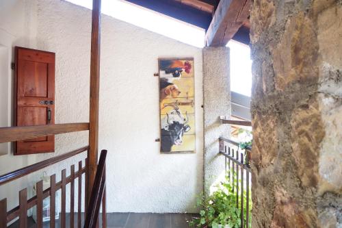 a painting on the side of a wall next to a door at Casa Cucuc in Frisanco