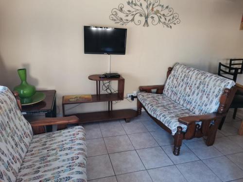 a living room with two couches and a tv at JoThams Bed & Breakfast or Self-catering in Durban