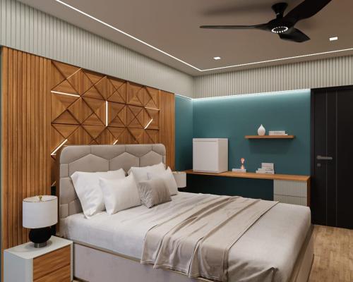 a bedroom with a large bed and a blue wall at THE GREENSTAR INN PREMIUM in Bhubaneshwar