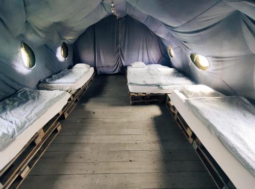 a room with three beds in a tent at Camp66 in Karpacz