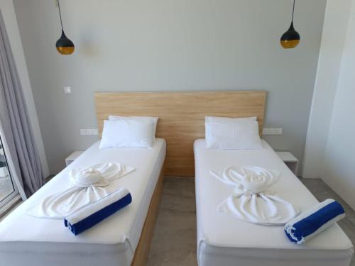 two beds sitting next to each other in a room at The Sunset Villa in Dhiffushi