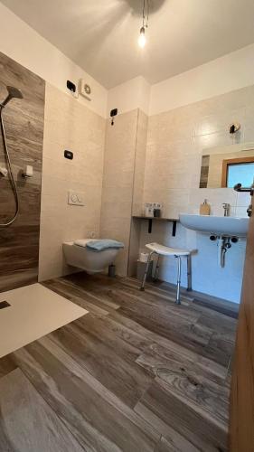 a bathroom with a sink and a tub and a toilet at Agritur Lavanda in Nave San Rocco