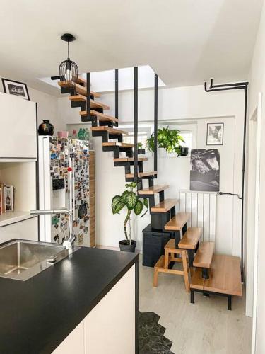a kitchen with a spiral staircase in a room at Apartment *MALA* in Žalec