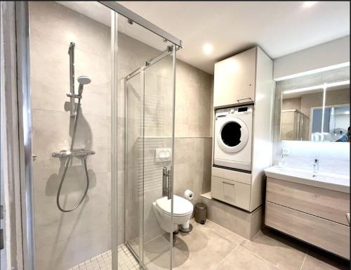 a bathroom with a shower toilet and a washing machine at 3 Pièces, Standing, Centre, 2 Sdb, 2 WC, Balcon in Deauville