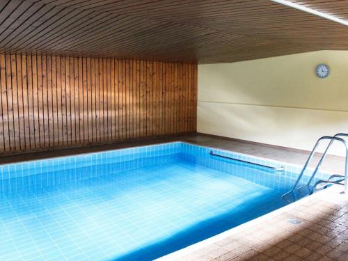 a large swimming pool with a wooden ceiling at Alpenwohnanlage Fewo La Rotonda in Grassau