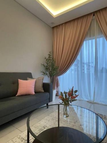a living room with a couch and a glass table at Biella Homestay Apartment for Muslim in Tanah Rata