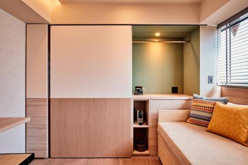 a living room with a couch and a window at LiveGRACE Hotel Azabu 麻布芝公園 in Tokyo