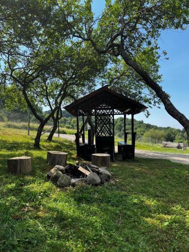 a gazebo sitting in the middle of a field at Rock Valley Cabins A-frame in Ibăneşti