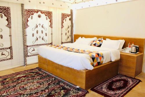 a bedroom with a bed in a room with a rug at The MAP Hotels in Jaisalmer