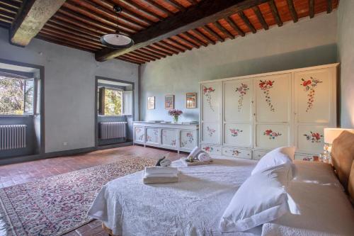 a bedroom with a bed in a room at Villa Trenta Prestigious Villa Enchanting Garden in Lucca