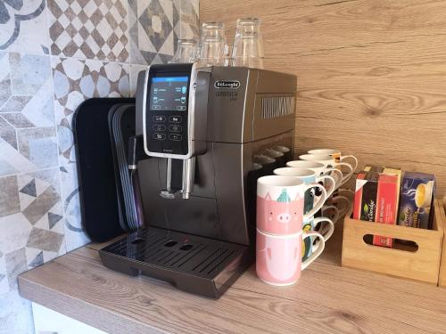 a coffee maker sitting on a counter with cups at Hotel Elvezia in Lavorgo