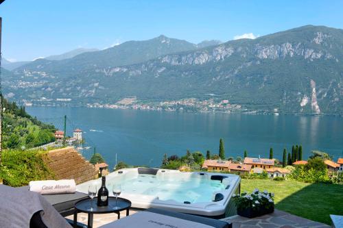 a hot tub on a patio overlooking a body of water at Casa Marina Bellagio private garden in Bellagio