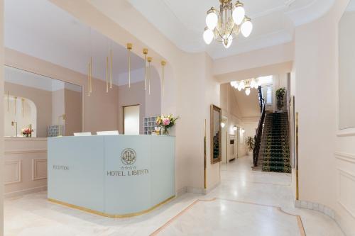 a large hallway with a reception desk in a building at Hotel Liberty in Prague