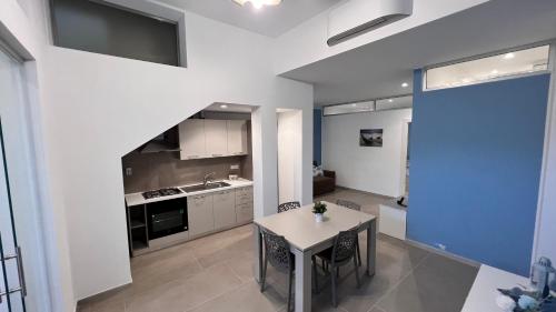 a kitchen with a table and a counter top at Case vacanze Cappero e Malvasia in Canneto