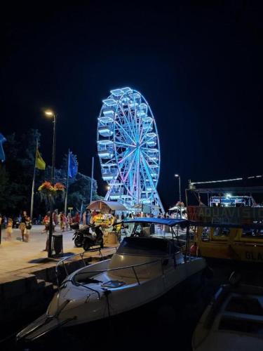 a ferris wheel at a carnival at night at SEA HOUSE pool & jacuzzi, bikes, SUP - PRIVILEGE POINT camping & villas in Selce