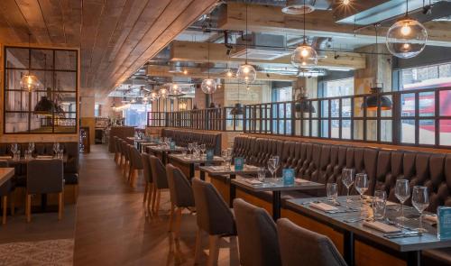 a row of tables and chairs in a restaurant at Maldron Hotel Finsbury Park, London in London