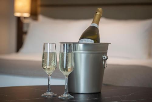 a bottle of champagne in a bucket and two glasses at Maldron Hotel Finsbury Park, London in London