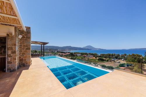 a swimming pool with a view of the water at Luxusvilla Pylos 6 Personen privater Pool in Gialova