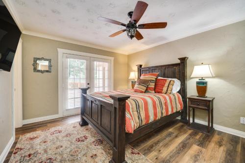 a bedroom with a bed with a ceiling fan at Charming Texarkana Home Lake and Pool Access! in Texarkana