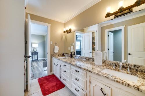 a bathroom with two sinks and a large mirror at Charming Texarkana Home Lake and Pool Access! in Texarkana