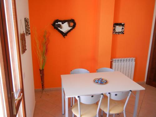 a dining room with a white table and two chairs at Il Sogno di Alghero - Adults Only in Alghero