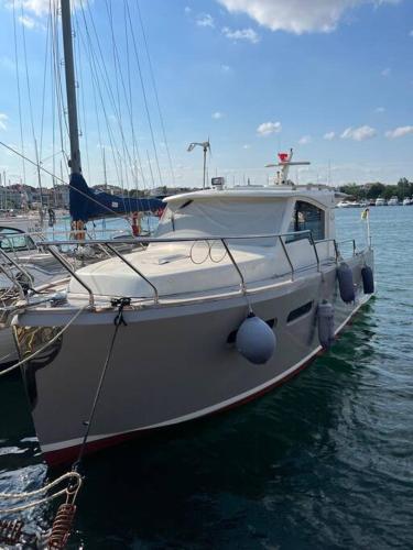 a white boat is docked in the water at At Yeşilköy harbour pretty Lobste Only Accommodation in Istanbul