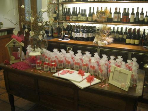 a counter with bottles of wine and a bunch of wine bottles at Albergo Esposito in Barzio