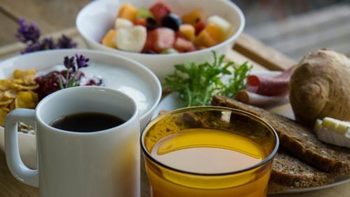a table with a cup of coffee and a plate of food at Danhostel Aarhus City in Aarhus