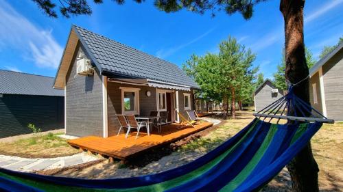 a hammock in front of a tiny house at Gorzewo Pora Relaksu in Gorzewo