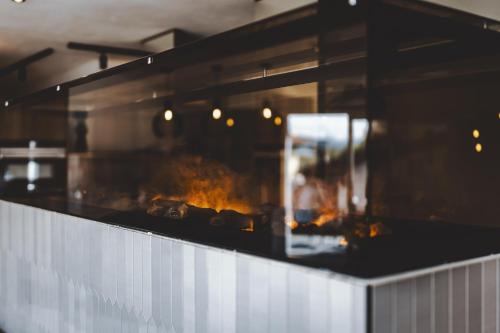 a counter with a fire inside of a restaurant at The Gast House Zell am See in Zell am See
