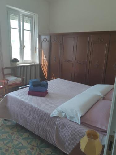 una camera da letto con un letto e due asciugamani di Dimora Palma di Barolo a Barolo