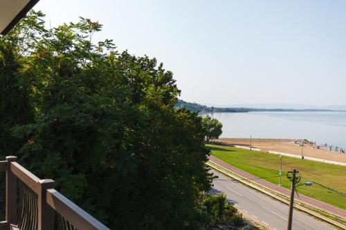 a view of the beach and water from the balcony of a house at Apartmani PORTO in Golubac