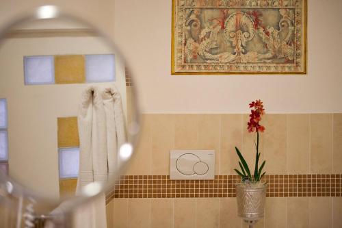 a bathroom with a mirror and a towel at Hotel Marinella in Marciana Marina