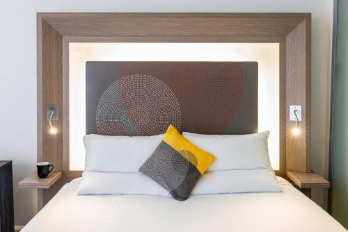 a bed with two pillows on top of it at Novotel Leeds Centre in Leeds