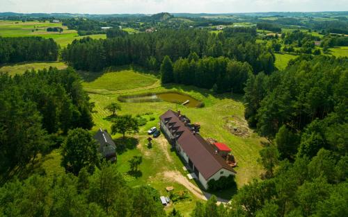 an aerial view of a farm with a barn at Agroturystyka Leśna Dolina 