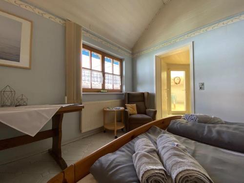 a room with two beds and a living room at Wohnung in Kleinfischlingen in Kleinfischlingen