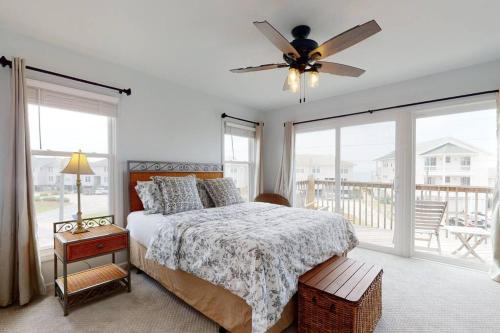 a bedroom with a bed and a ceiling fan at Oceanview Townhouse w/ Pool - Newly Renovated in Surf City