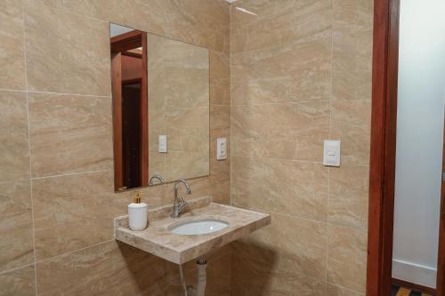 a bathroom with a sink and a mirror at Hotel pousada Krone Praia de Iracema Fortaleza in Fortaleza