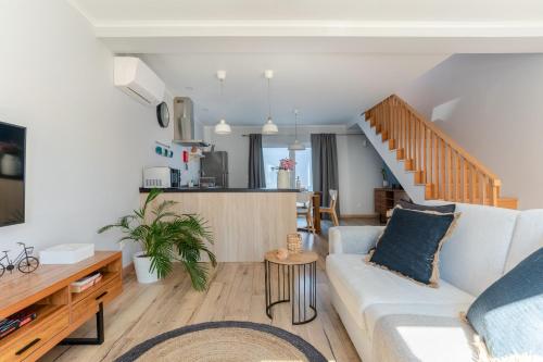 a living room with a couch and a table at Windmill Escape - Areia Townhouse by Lisbeyond in Odeceixe