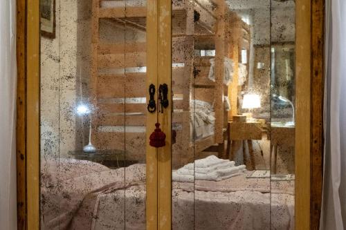 a glass door with a bed in a room at Cianis Home San Marco - Apartment in Venice