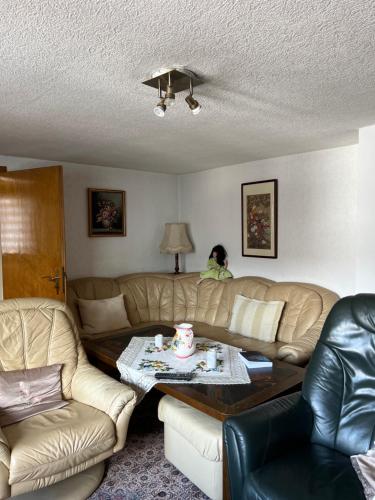 a living room with two couches and a coffee table at Gemütliche Wohnung im Herzen vom Dorf in Mudersbach