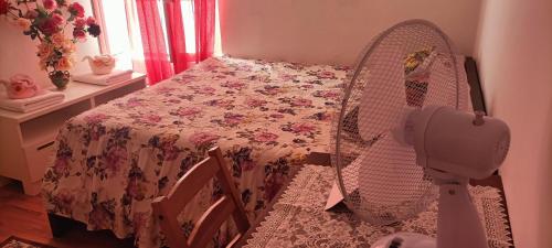 Camera con letto, tavolo e ventilatore. di SGA a Trieste