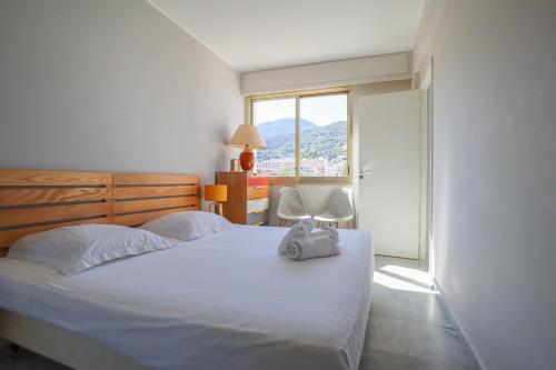 a bedroom with a bed with a towel on it at « Les Ligures » Calme, Proche Mer in Roquebrune-Cap-Martin
