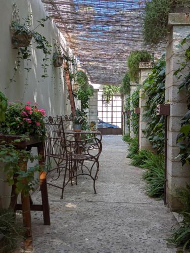 a patio with chairs and plants in a greenhouse at Borgo San Gaetano in Bernalda